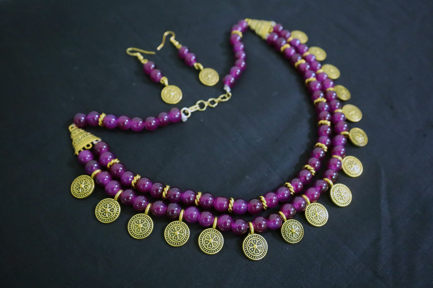 Angle view of amethyst 2 layered glass beads and golden ginni necklace set