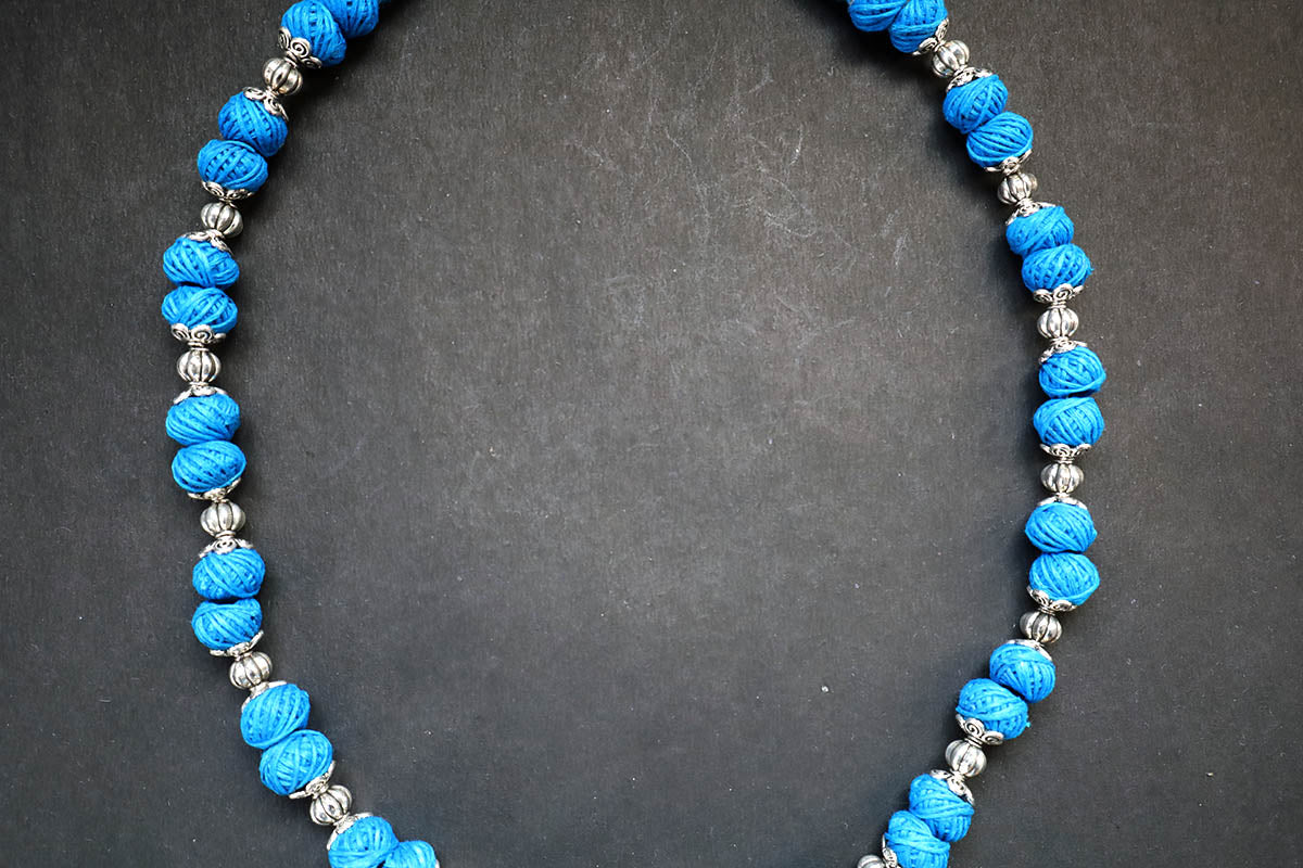 Close-up of middle portion of oxidized and cotton balls blue long necklace – fashion jewellery for women