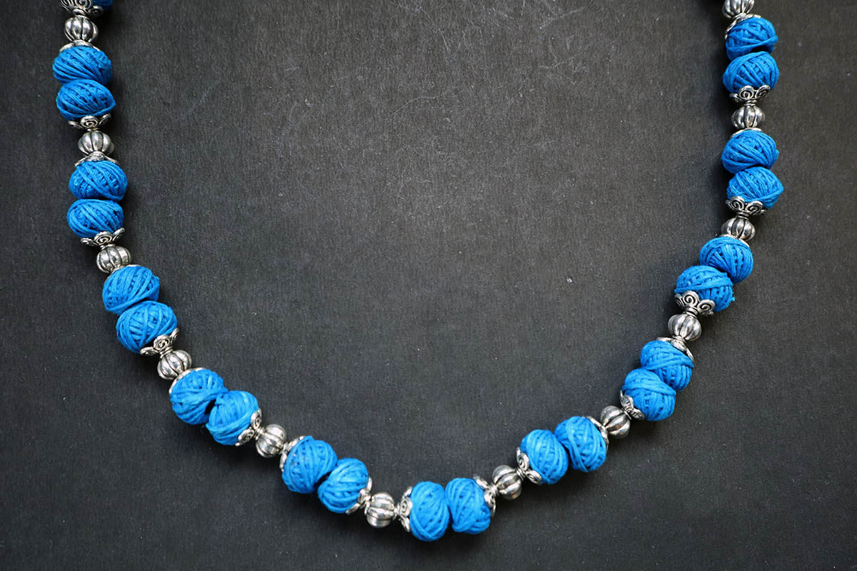 Bottom section close-up of oxidized and cotton balls blue long necklace – fashion jewellery for women