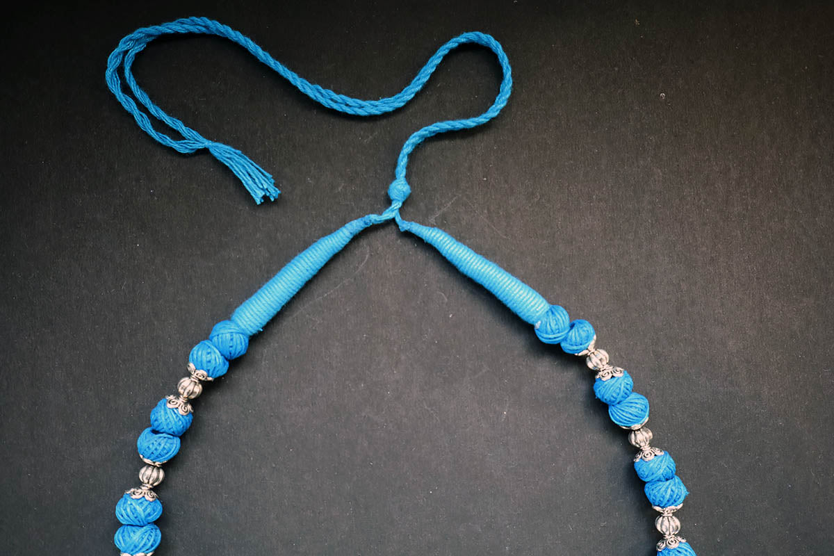 Showing the knot structure of handmade oxidized and cotton balls blue long necklace – fashion jewellery for women