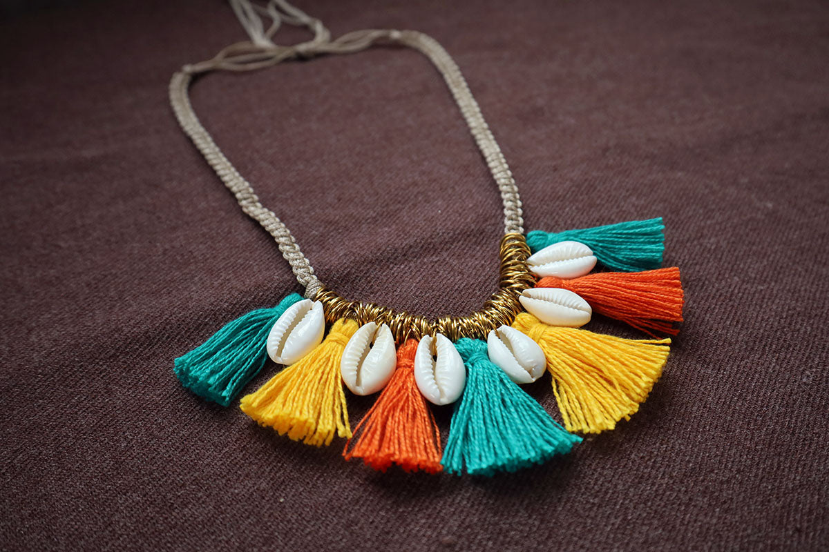Perspective view of short tassel and cowrie multicolored necklace – fashion jewellery for women