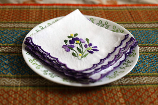 Side angle view of Violet Hand Embroidery Napkin Set, showcasing the elegant violet stitching and soft cotton texture