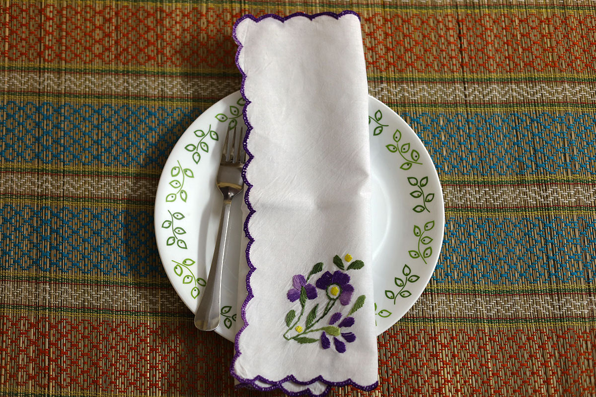 Violet Hand Embroidery Napkins folded neatly with violet floral and green embroidery accents