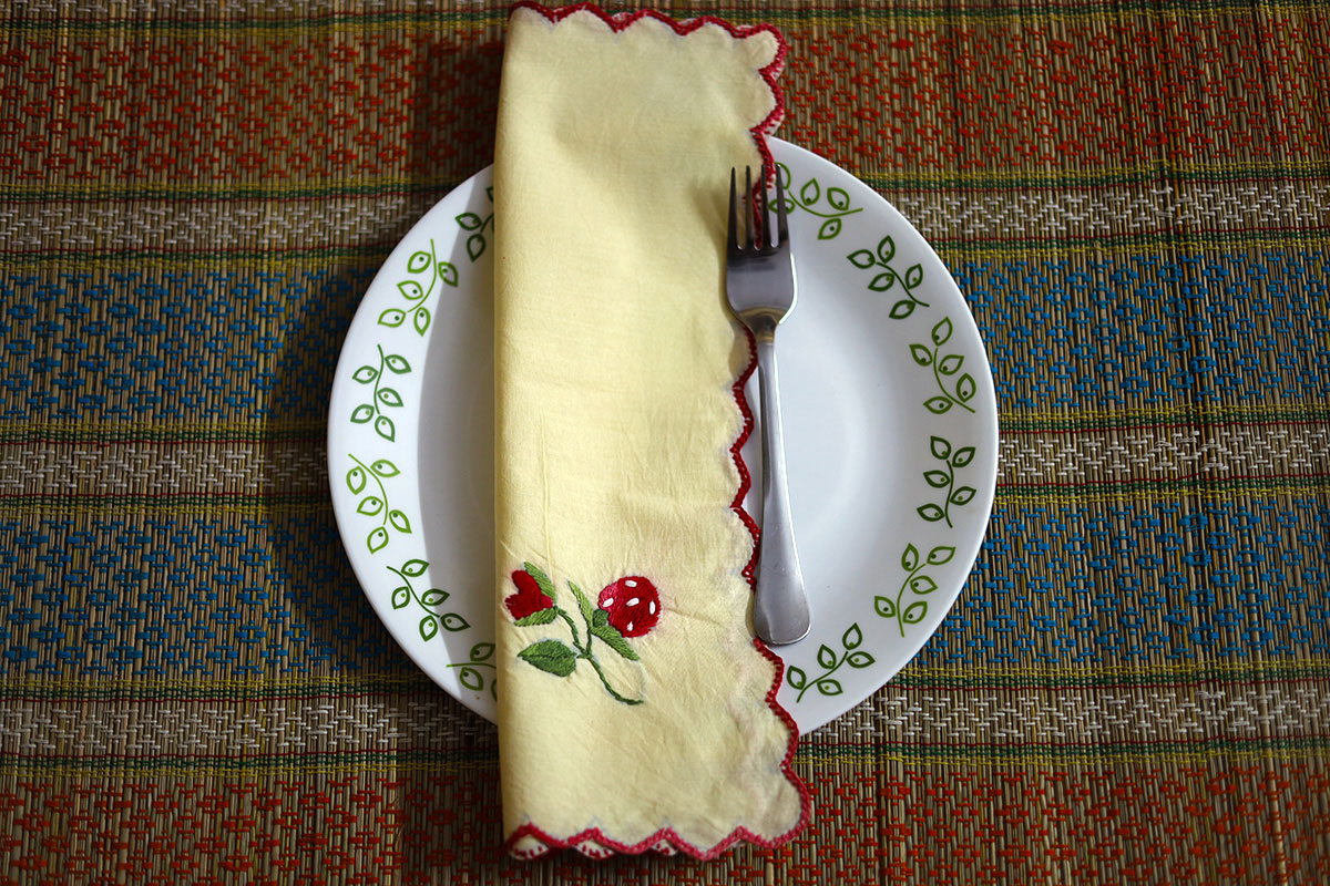 Wine Red Hand Embroidery Napkin folded neatly, displaying sophisticated wine red and green embroidery