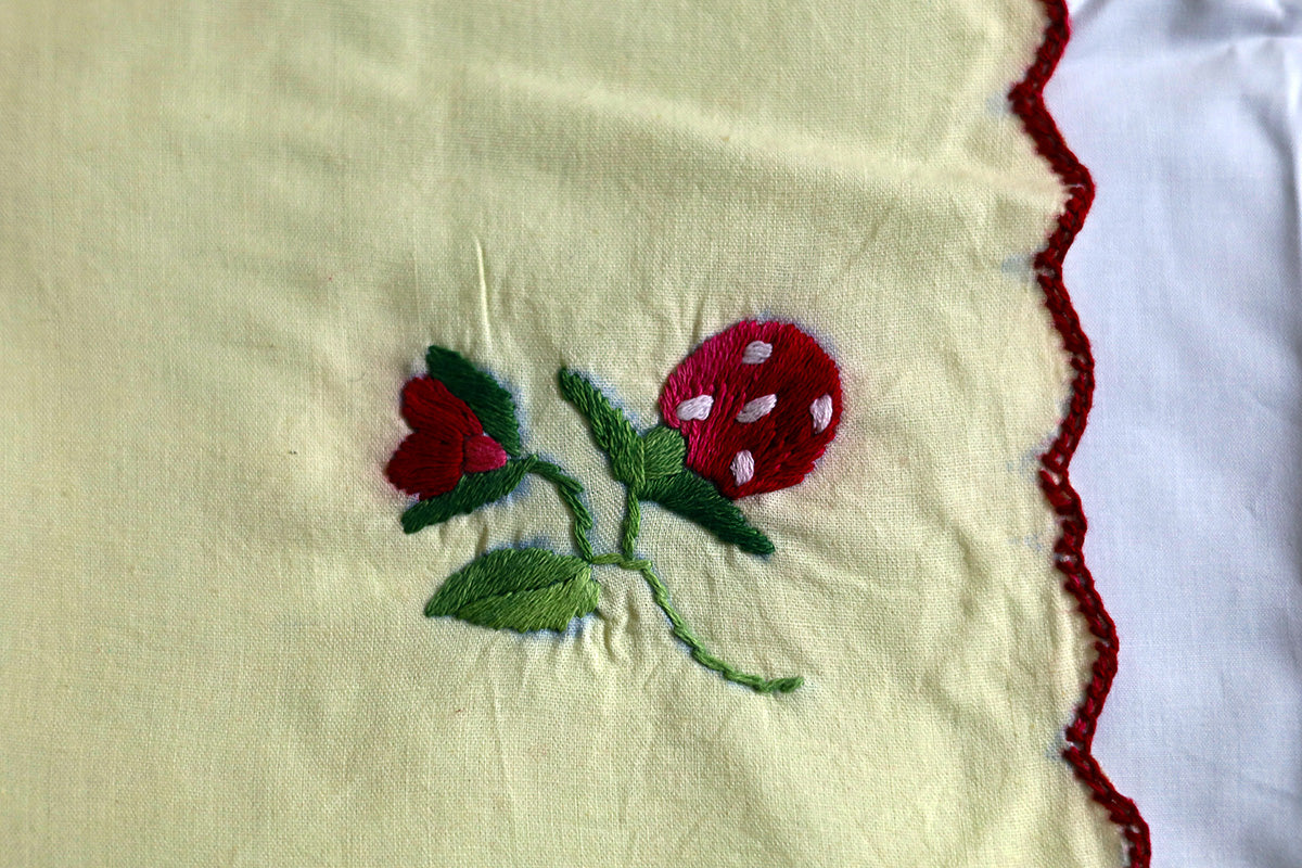 Close-up of the detailed embroidery work on the Wine Red Hand Embroidery Napkins, showcasing rich red and green threadwork