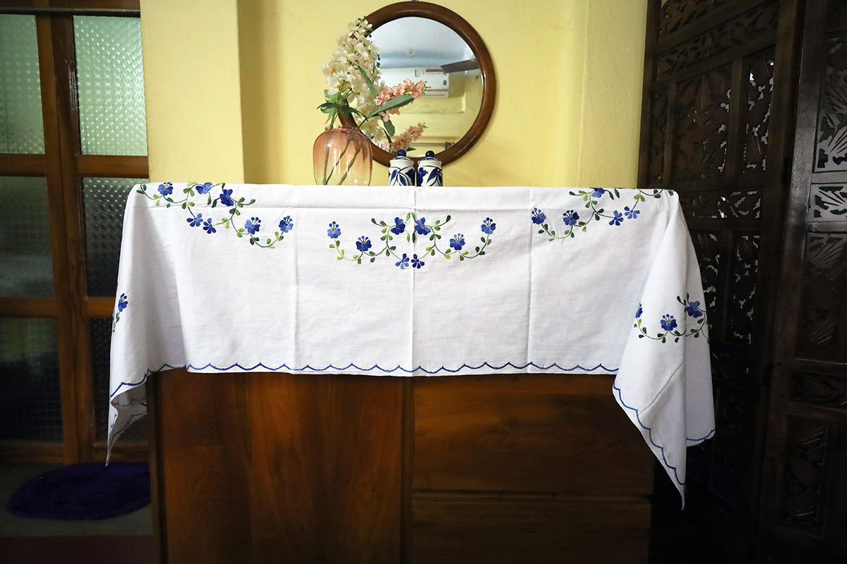 Full view of Blue Hand Embroidery Table Cloth elegantly paired with a chest of drawers, featuring its artisanal embroidery.
