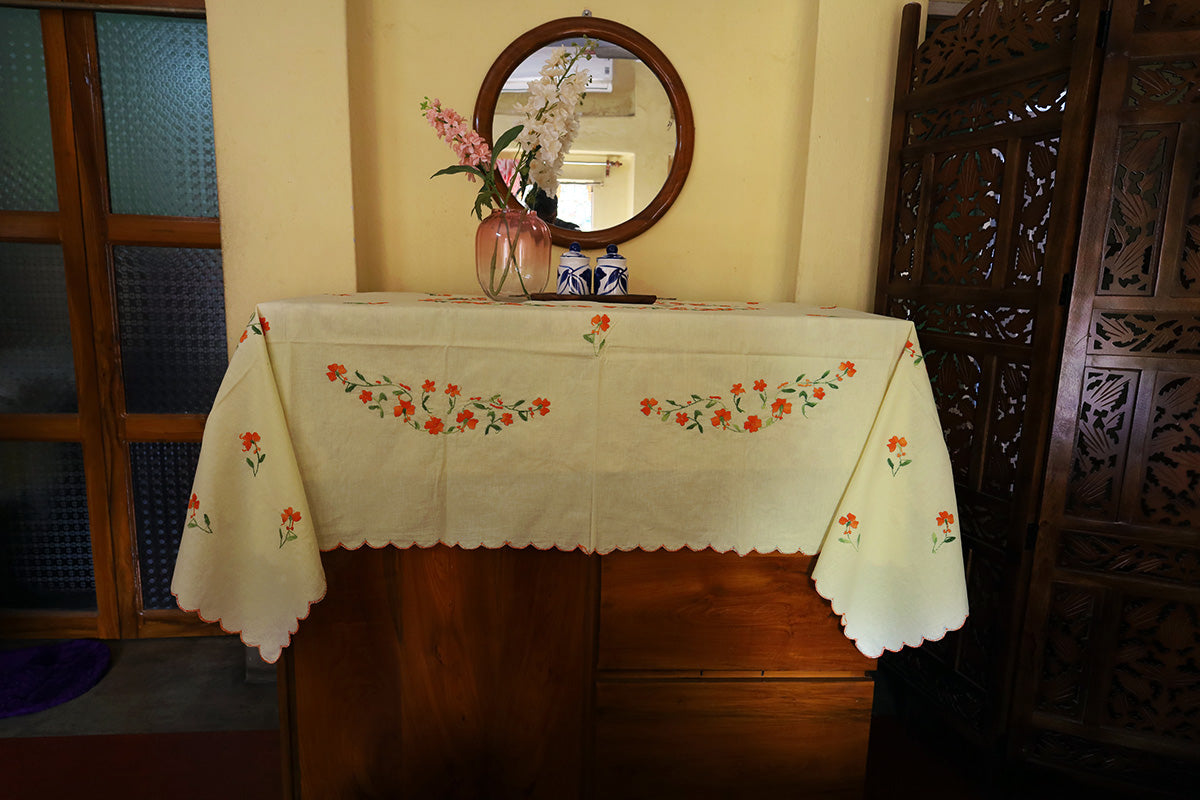 Full view of Bright Orange Hand Embroidery Table Cloth styled with a chest of drawers, featuring vibrant and intricate embroidery.