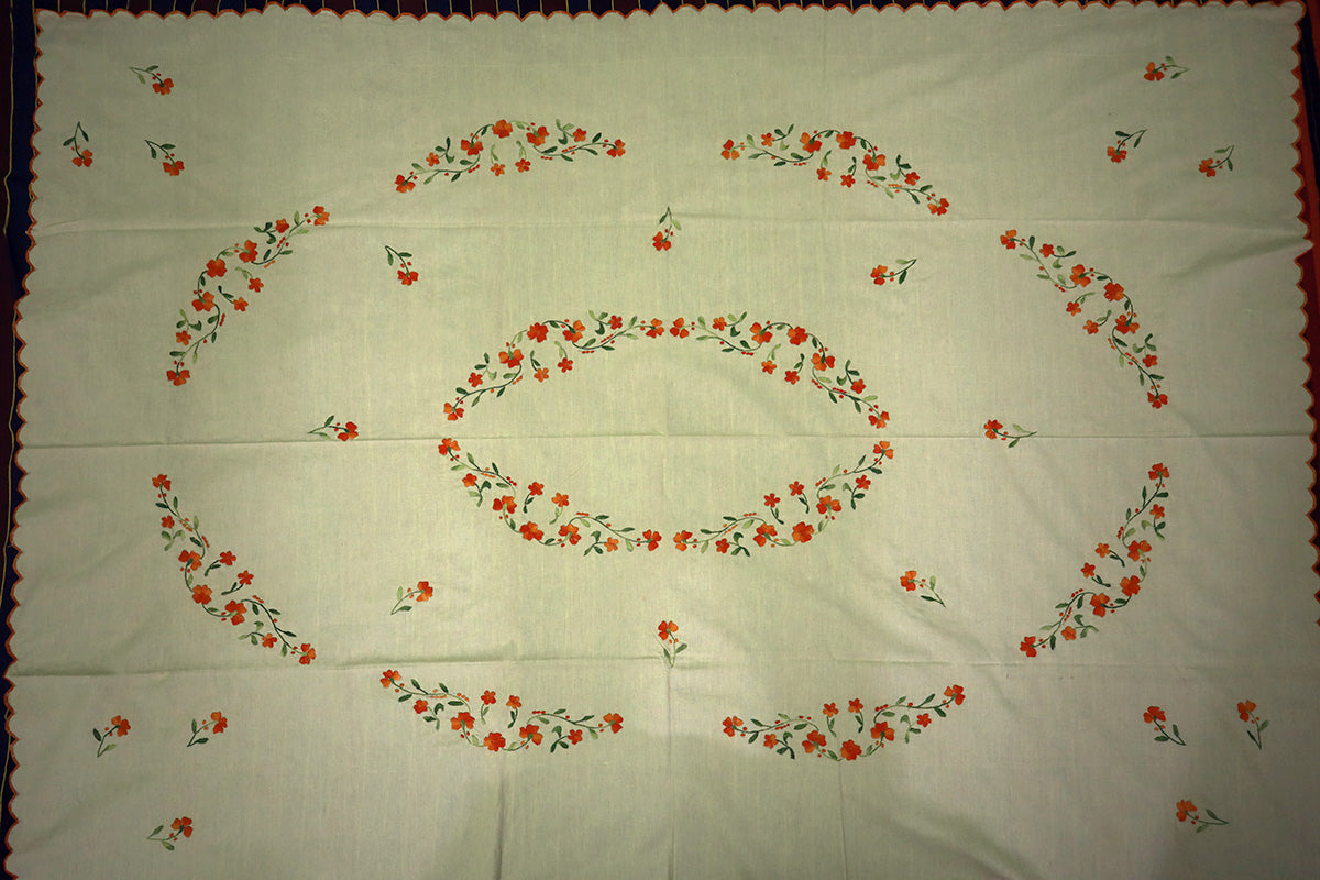 Top-angle view of Bright Orange Hand Embroidery Table Cloth with a chest of drawers, showing its full artistic design.