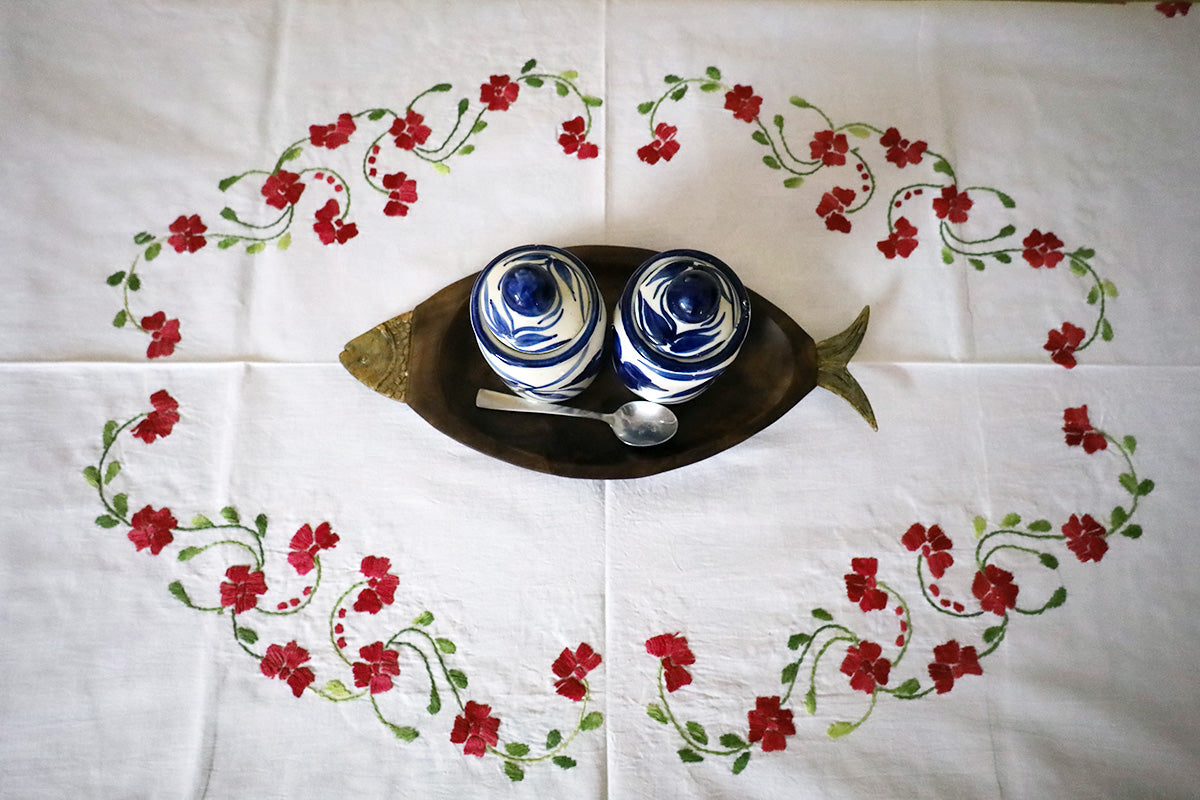 Top view of Crimson Red Hand Embroidery Table Cloth showcasing vibrant embroidery over a chest of drawers.