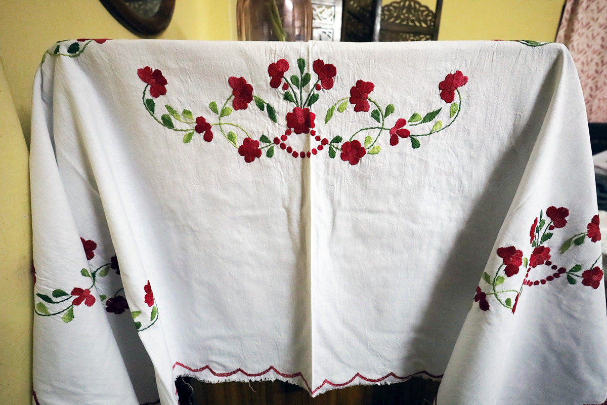 Full view of Maroon Hand Embroidery Table Cloth styled on a chest of drawers, showcasing its bold, handcrafted design.