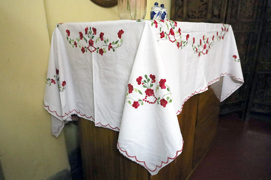 Side angle of Maroon Hand Embroidery Table Cloth with a chest of drawers, emphasizing its vibrant embroidery details.