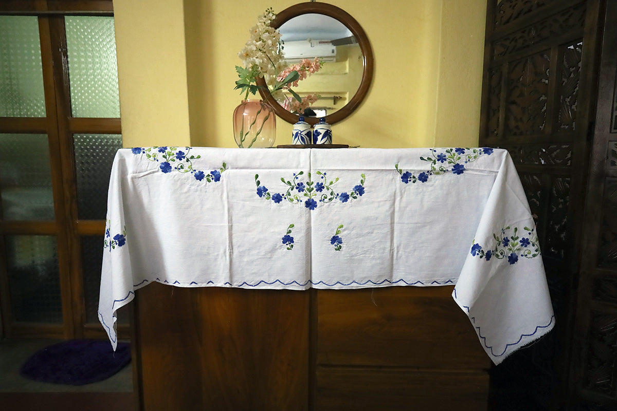 Full view of Navy Blue Hand Embroidery Table Cloth paired with a chest of drawers, showcasing its elegance and artistry.