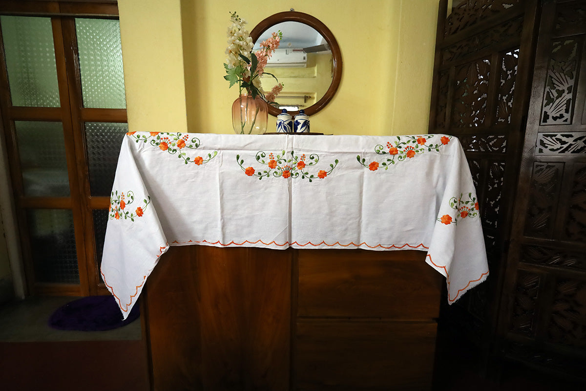 Full view of Orange Hand Embroidery Table Cloth styled with a chest of drawers, showcasing its elegance and handcrafted designs.