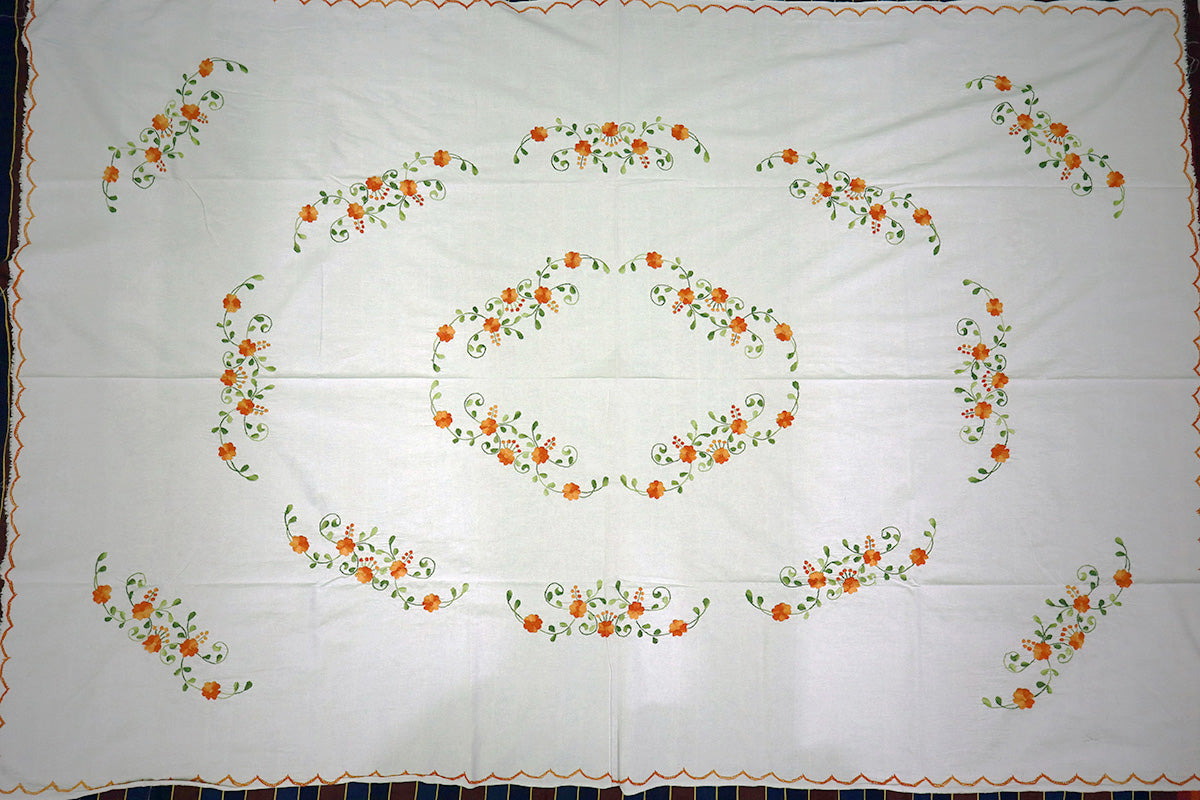 Complete top-angle shot of Orange Hand Embroidery Table Cloth with a chest of drawers, showcasing its full design and craftsmanship.