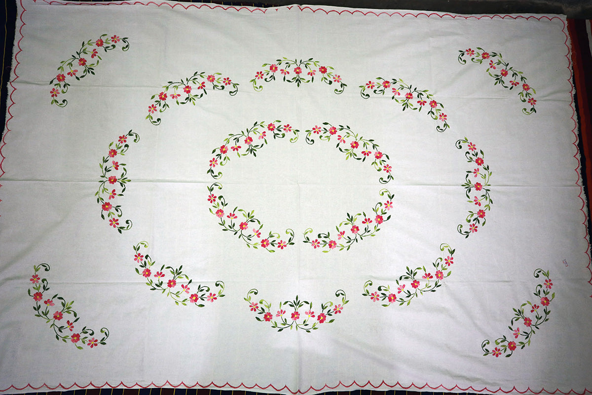Top-angle view of Pink Hand Embroidery Table Cloth with a chest of drawers, displaying its complete design.