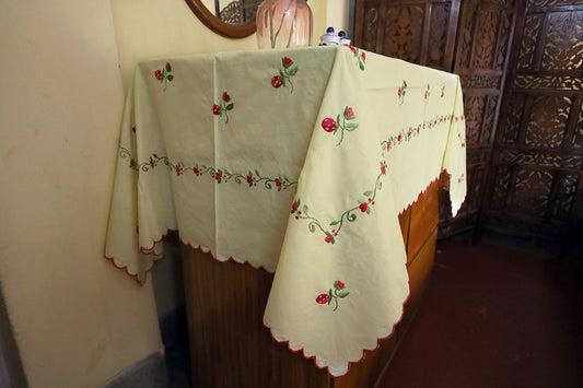 Side angle of Wine Red Hand Embroidery Table Cloth paired with a chest of drawers, highlighting its elegant designs.