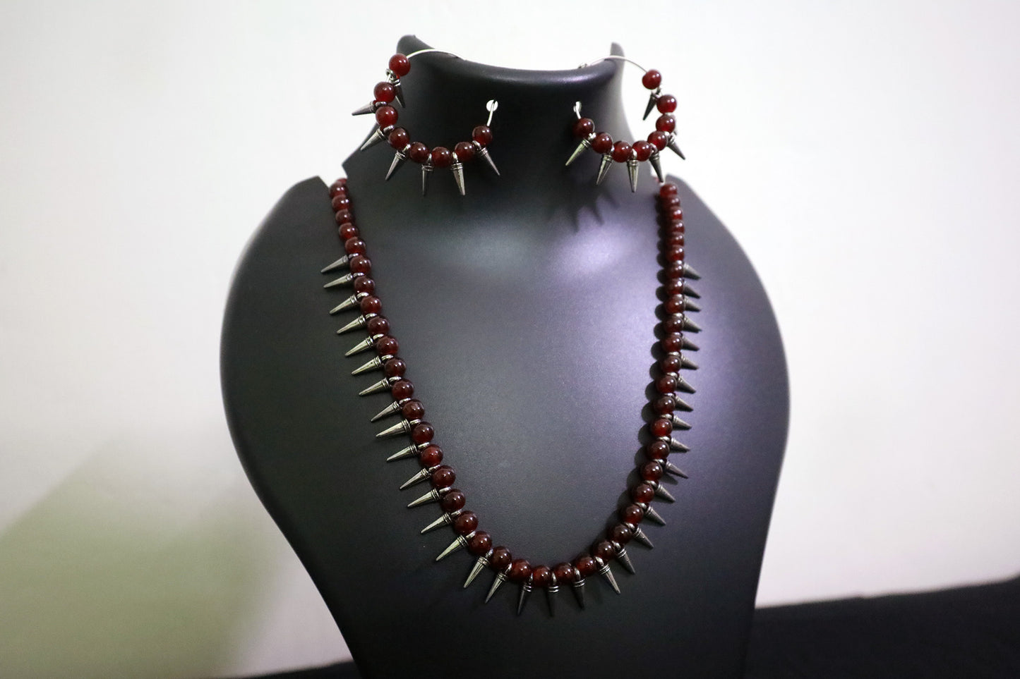 Closer view of Maroon Glass Beads Oxidized Cone Necklace Set on mannequin – handmade jewellery