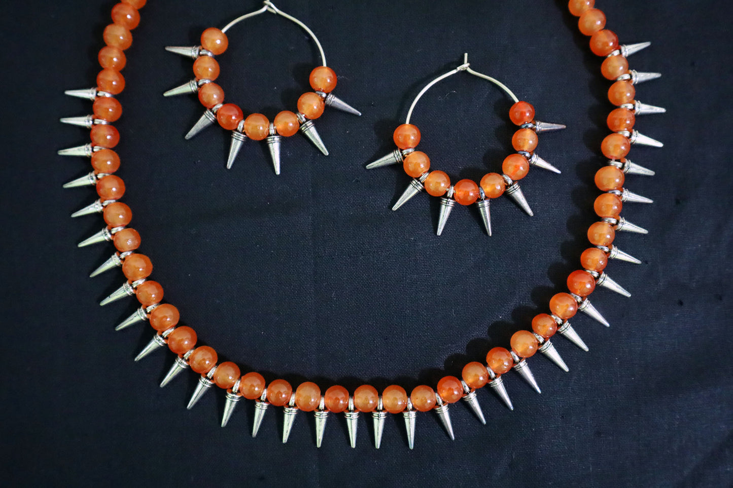Bottom close-up of Orange Glass Beads Oxidized Cone Necklace with earrings – artificial jewellery