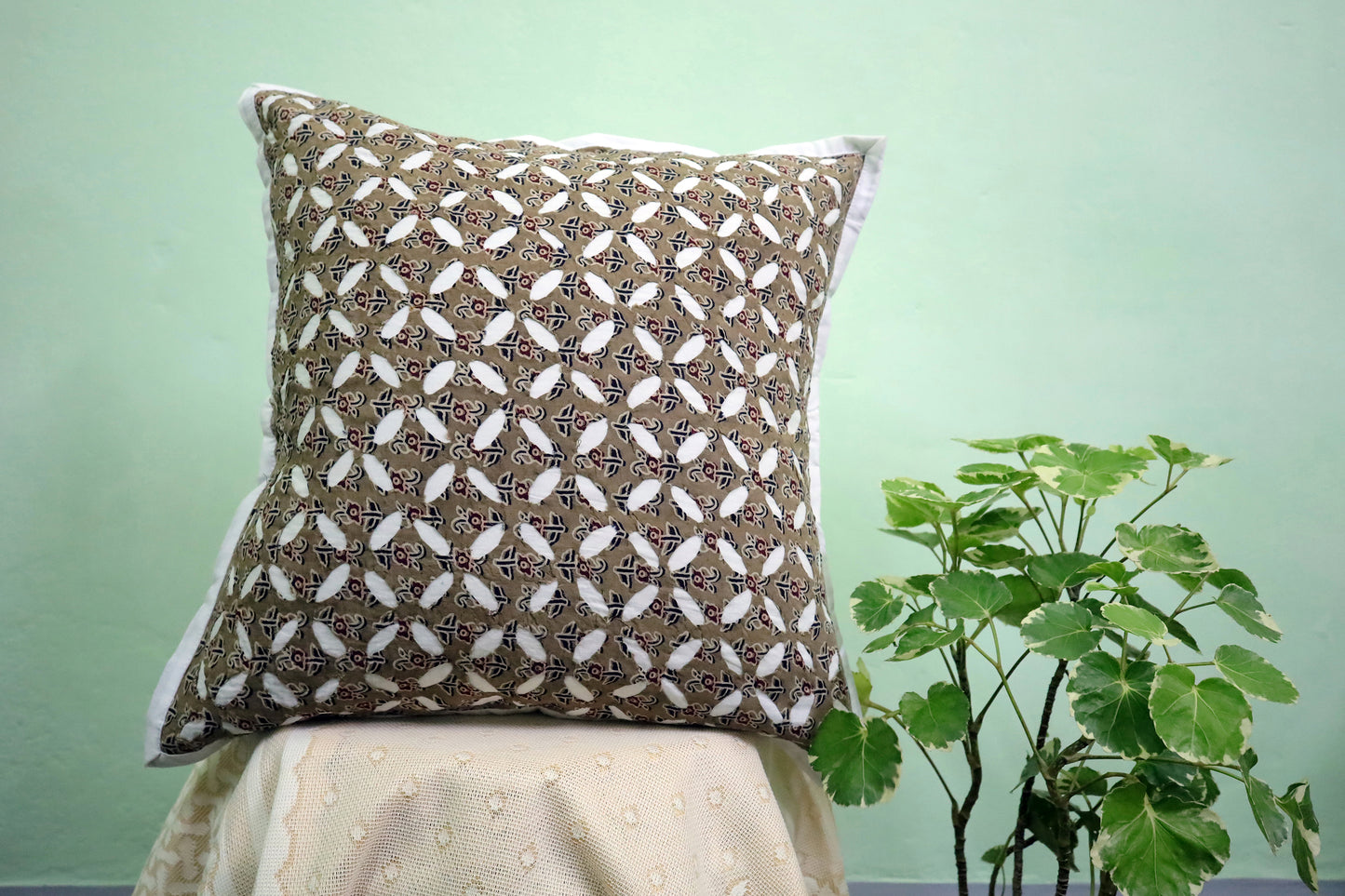 A beautiful display of a Maroon Cutwork Ajrakh Print Cushion Cover