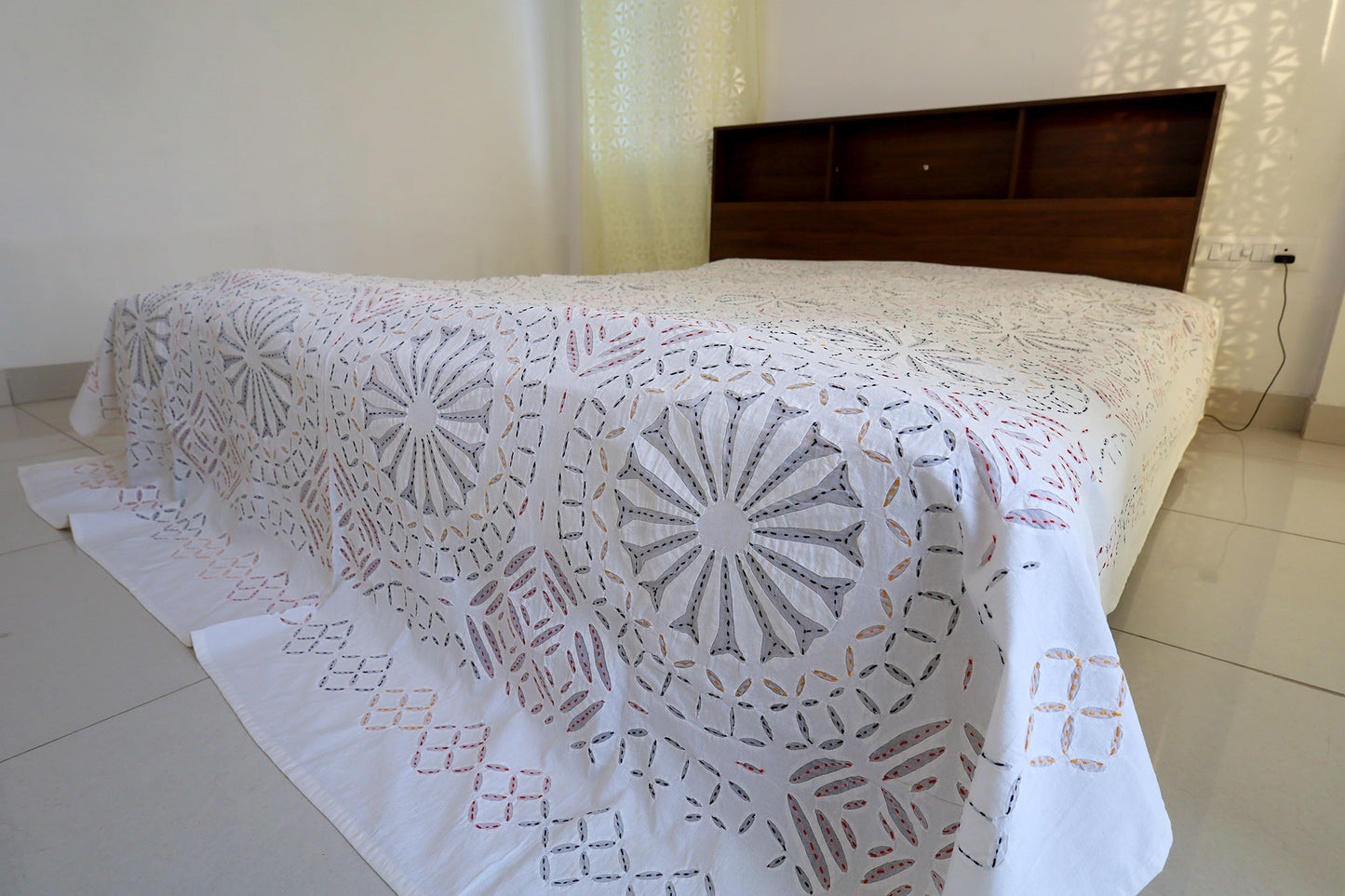 Side angle view of cotton bed cover styled on bed