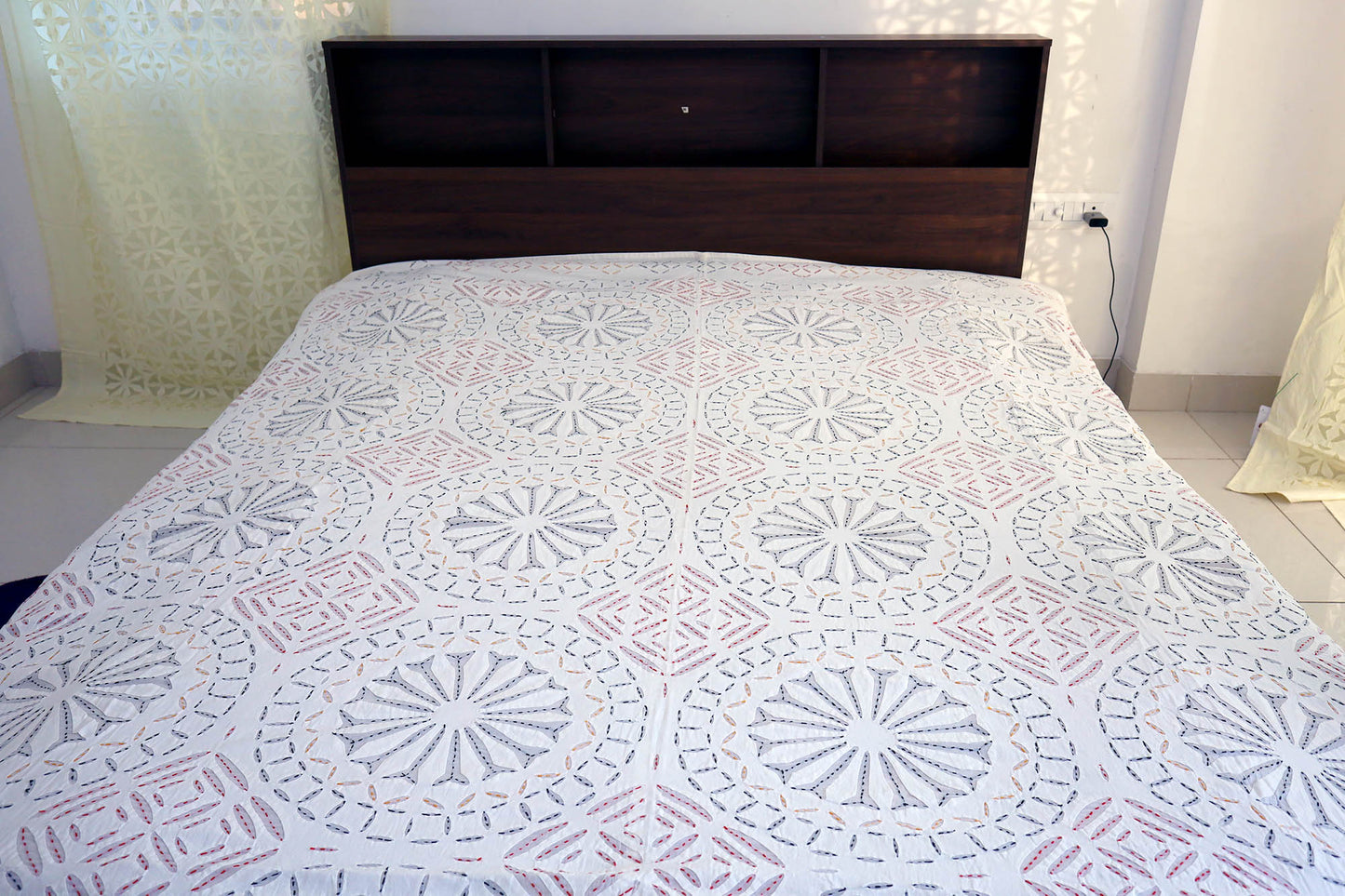 Top view of cotton double bed cover with applique cutwork