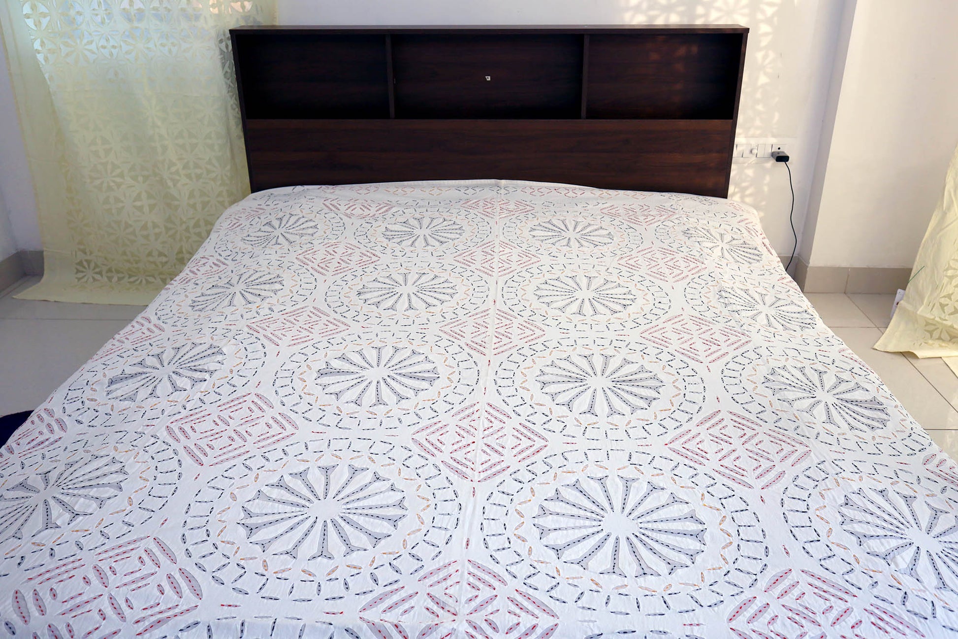 Top view of cotton double bed cover with applique cutwork