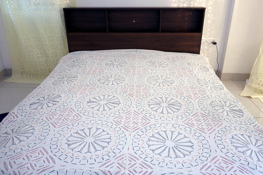 Top view of cotton double bed cover with applique cutwork