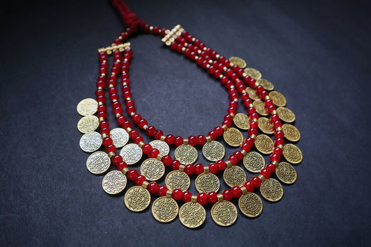 Perspective view of 3 layered golden ginni and glass beaded long necklace on a dark background – women fashion jewellery