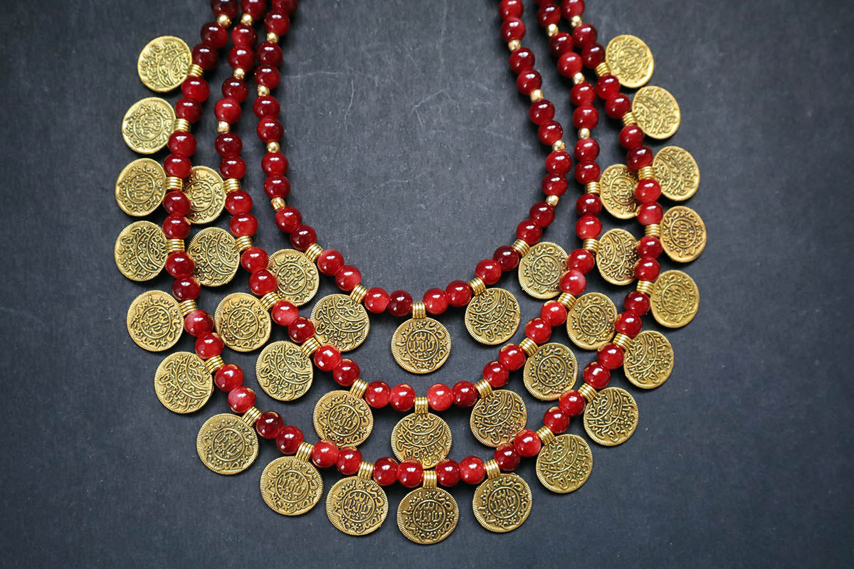 Bottom close-up of 3 layered golden ginni & glass beaded long necklace on a dark background – artificial jewellery for women