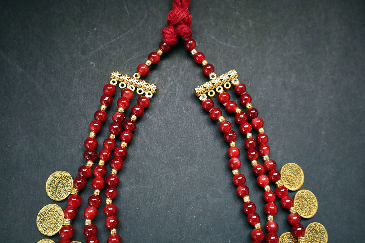 Showing knot structure of handmade 3 layered ginni and glass beaded long necklace on a dark background – artificial jewellery