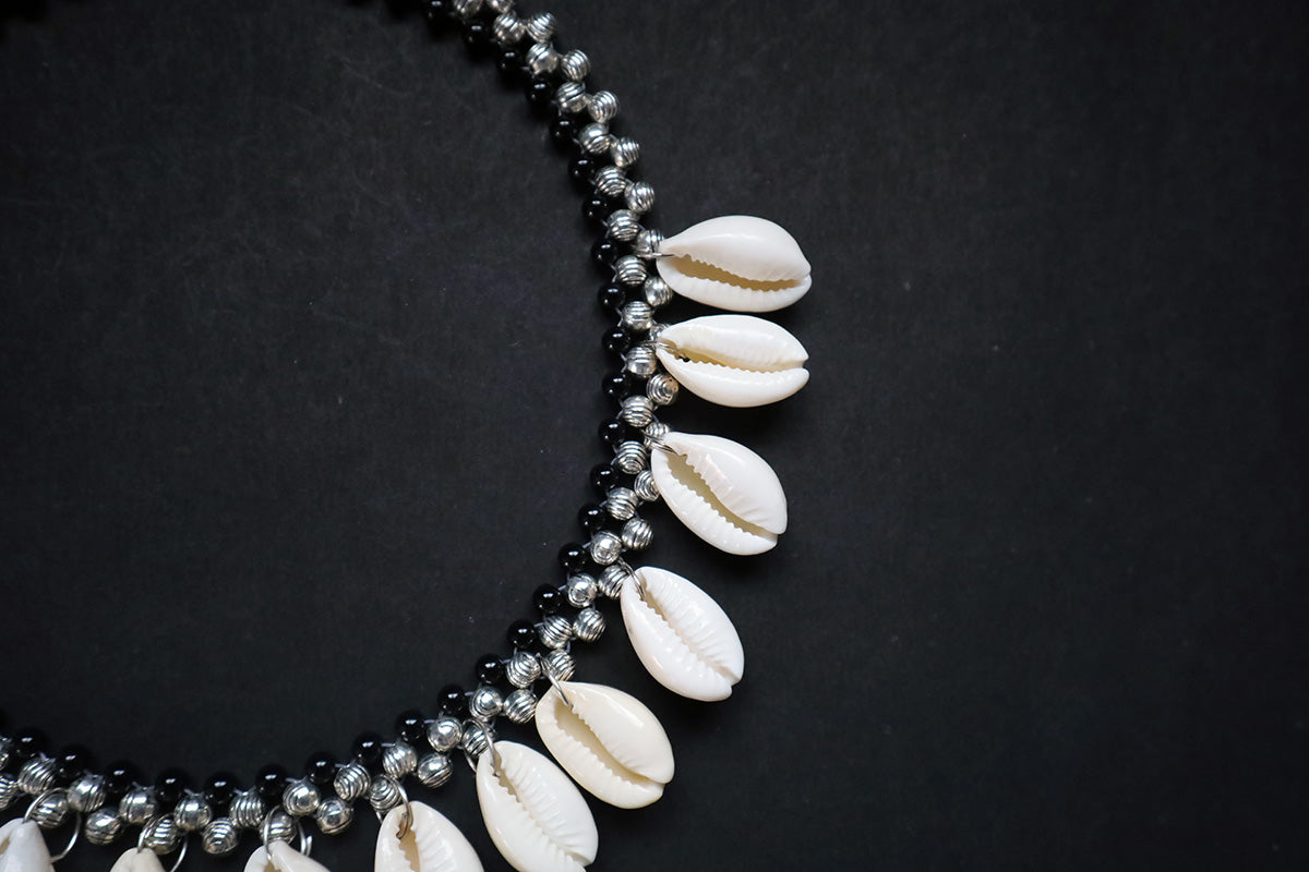 Close-up of right portion of metal beads and cowrie silver colored – fashion jewellery for women