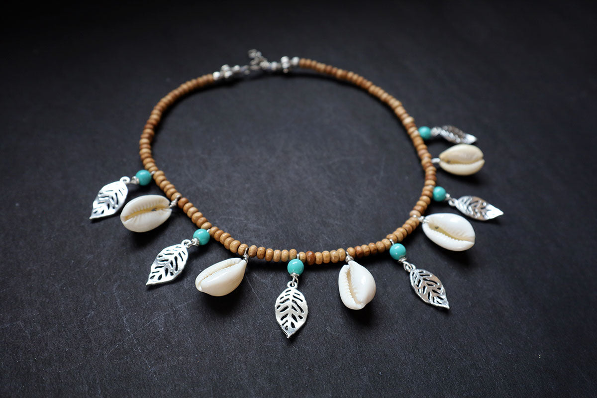 Perspective view of wooden beads short necklace with cowrie, oxidized leaf charms – fashion jewellery for women