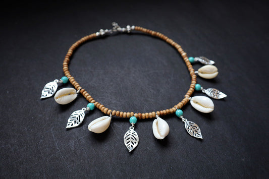 Perspective view of wooden beads short necklace with cowrie, oxidized leaf charms – fashion jewellery for women