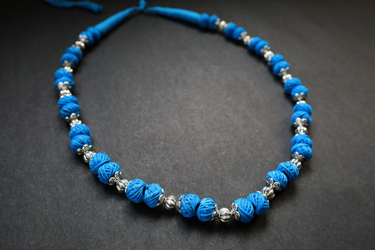 Perspective view of oxidized and cotton balls blue long necklace – fashion jewellery for women