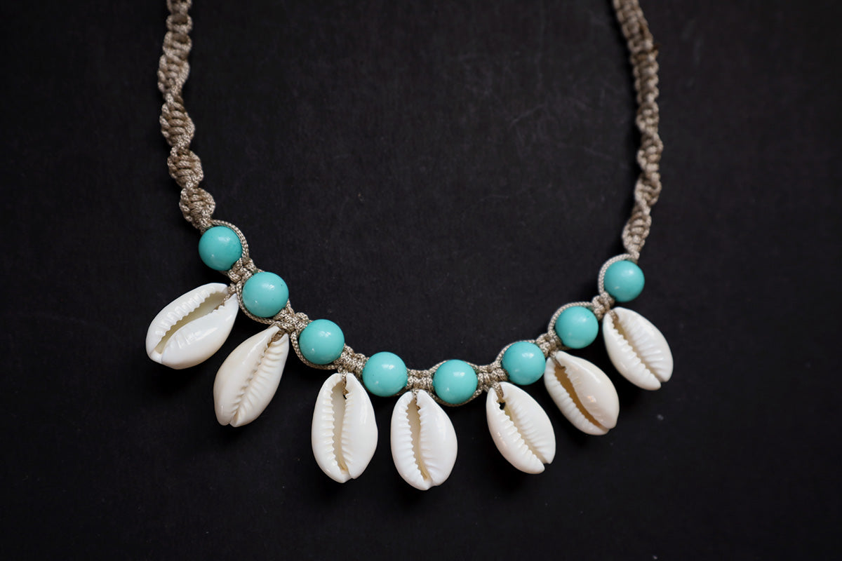 Bottom section close-up of hemp weaved short necklace with plastic beads and cowrie – fashion jewellery for women