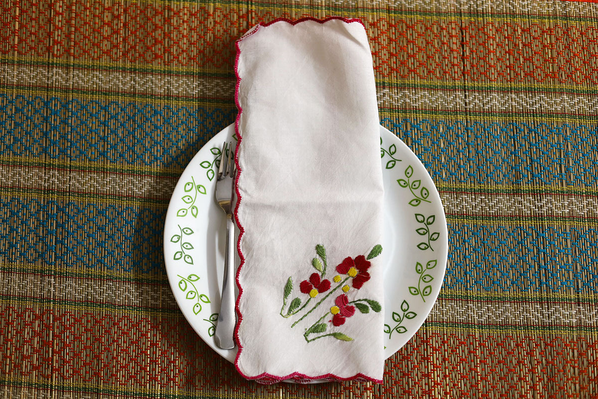 Crimson Red Hand Embroidery Napkins folded, showcasing intricate crimson red embroidery with green detailing