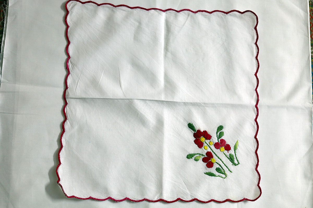 Full view of Crimson Red Hand Embroidery Napkins, displaying rich crimson and green embroidery on soft cotton fabric