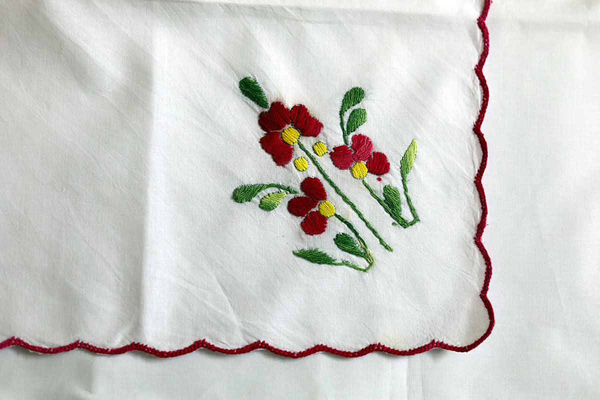 Close-up of the intricate crimson red and green embroidery on the Crimson Red Hand Embroidery Napkins