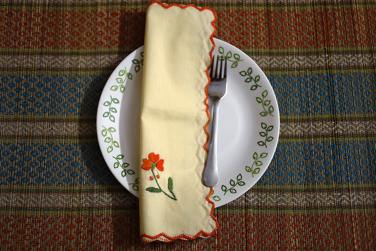 Orange Hand Embroidery Napkins folded neatly, highlighting the embroidered design and vibrant color