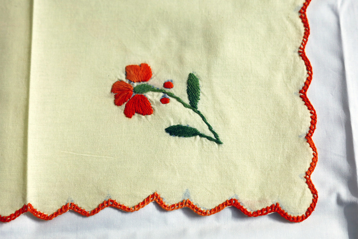 Close-up view of detailed hand embroidery on the Orange Hand Embroidery Napkins, showcasing delicate stitching