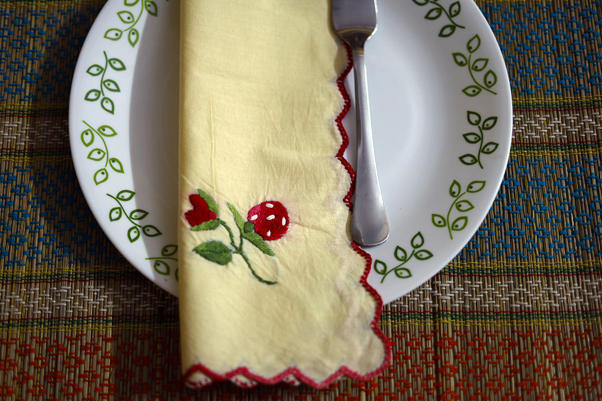 Close-up of Wine Red Hand Embroidery Napkin folded, featuring beautiful wine red floral embroidery on cotton