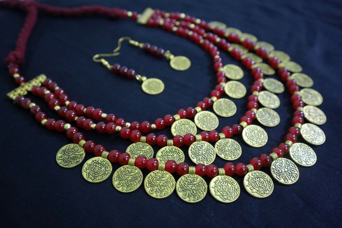 Angle view of 3 layered glass beads golden ginni necklace set with earrings